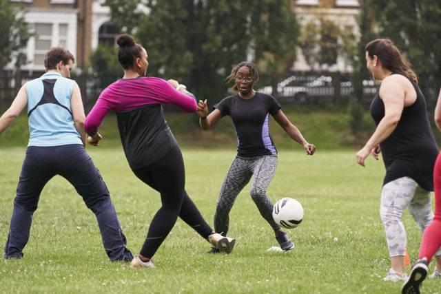 A group of people are playing football